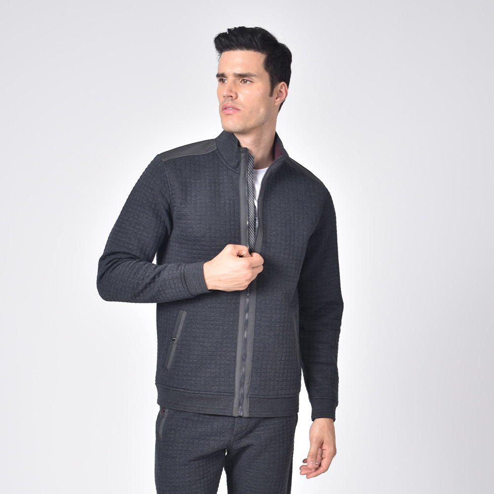 Model in grey, quilted track jacket with full front-zipper and front snap-button pockets.