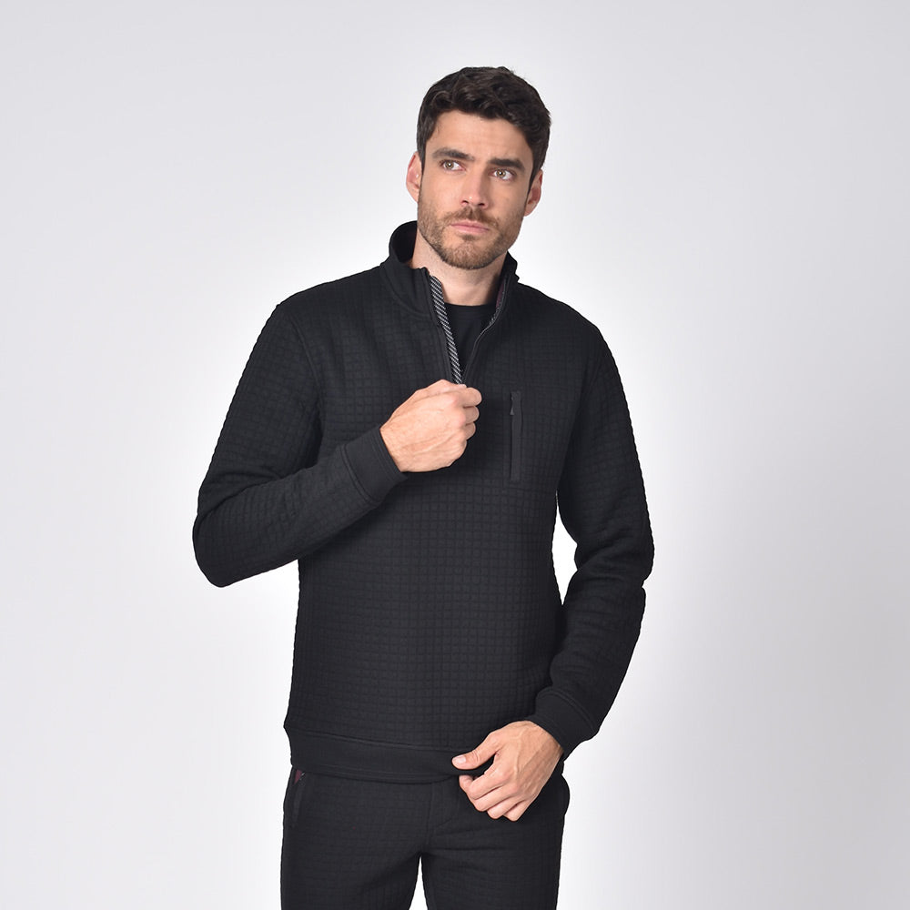 Model in black, quilted track jacket with full front-zipper and side snap-button pockets.