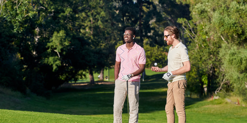 two men standing on a golf course