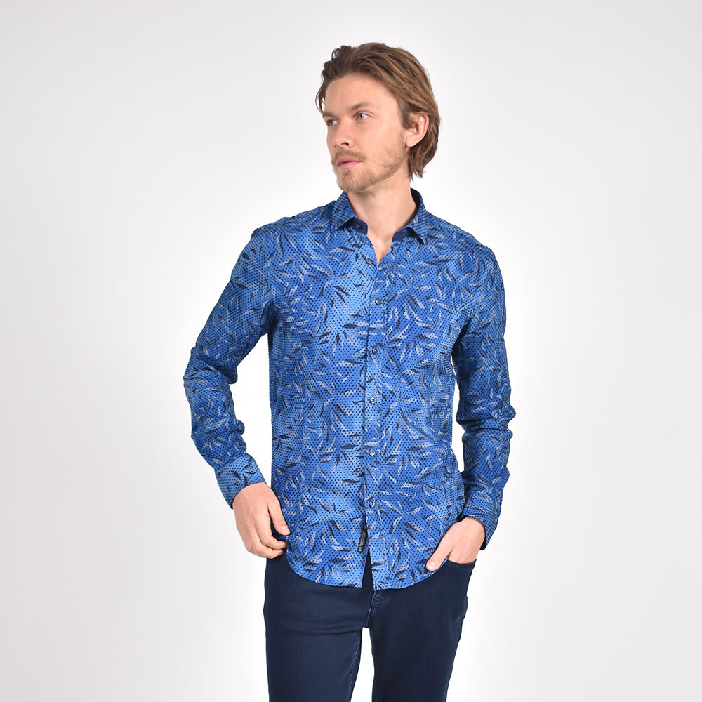 Model in royal-blue button up with leaf pattern and polka dot flocking.
