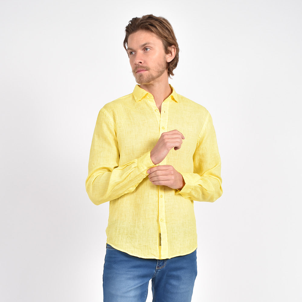 Model in long-sleeve, yellow linen button-up. 