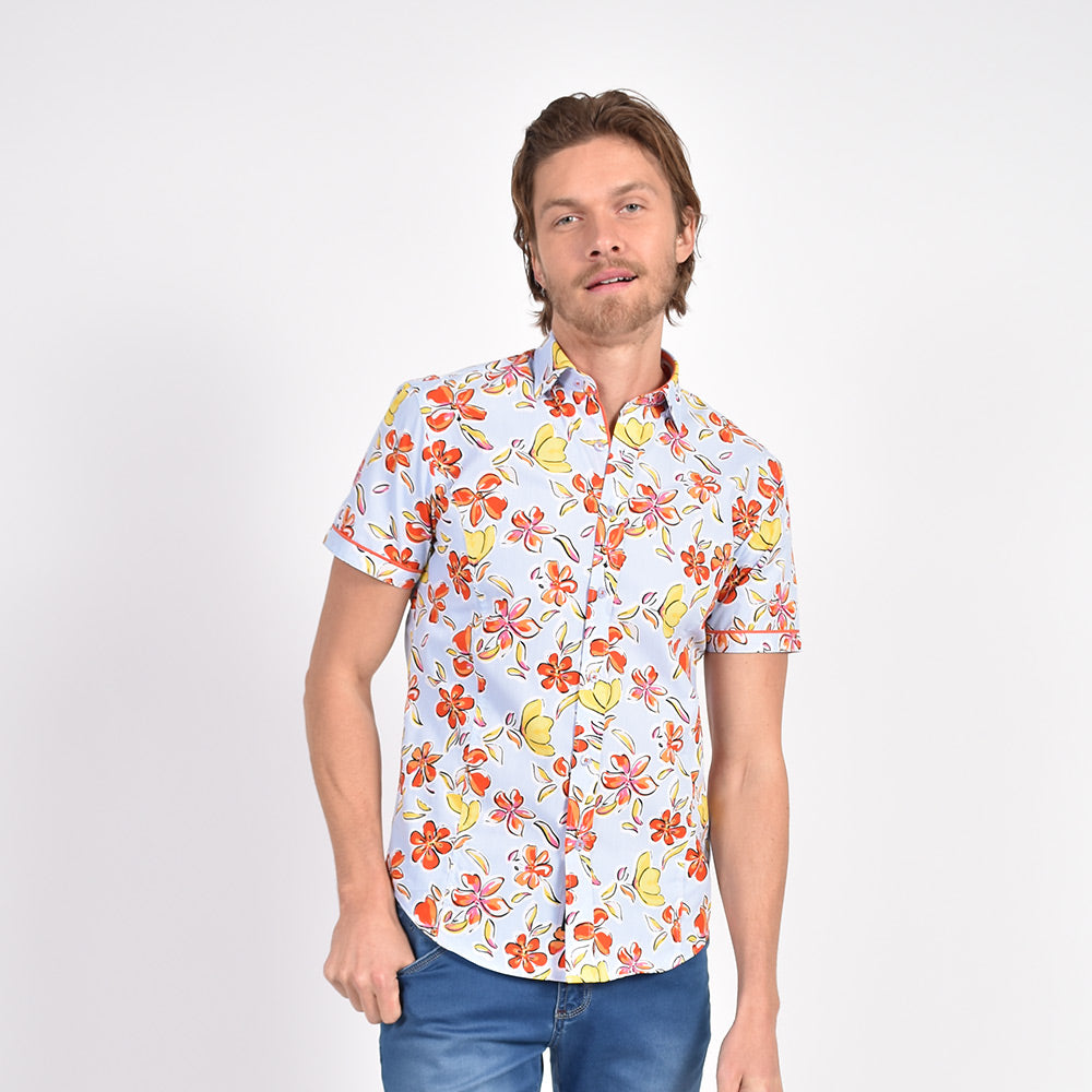 Model in folded light blue button-up with orange, Hawaiian flower print.