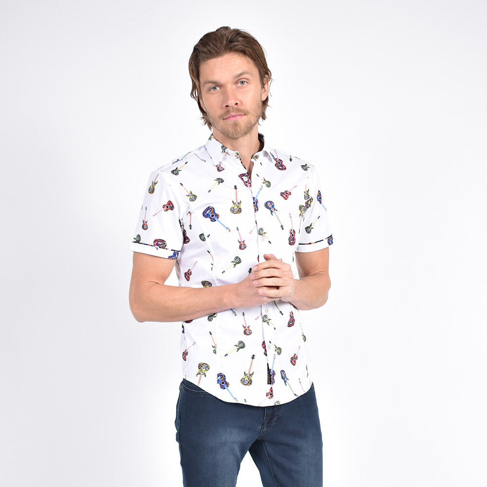 Model in short-sleeve white button-up with colorful guitar print.