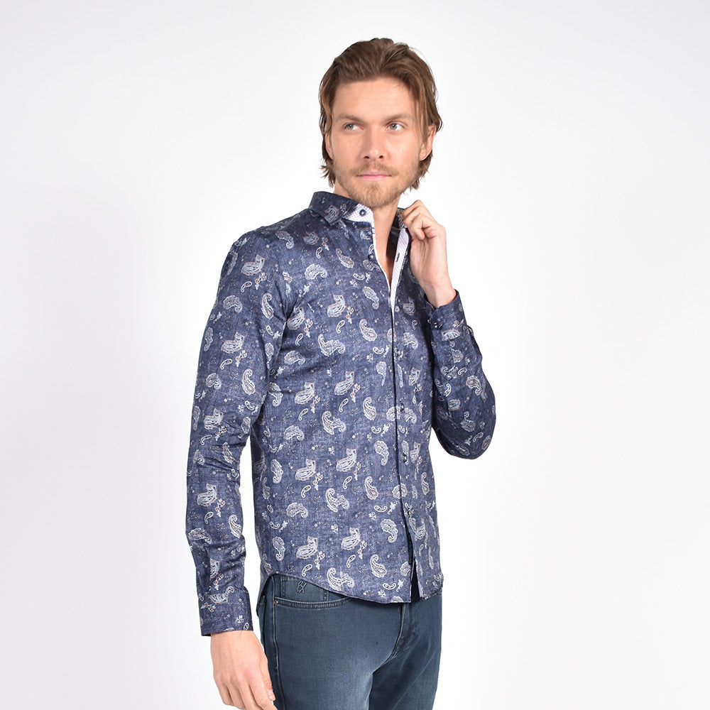 Model in navy button-up with white paisley print.