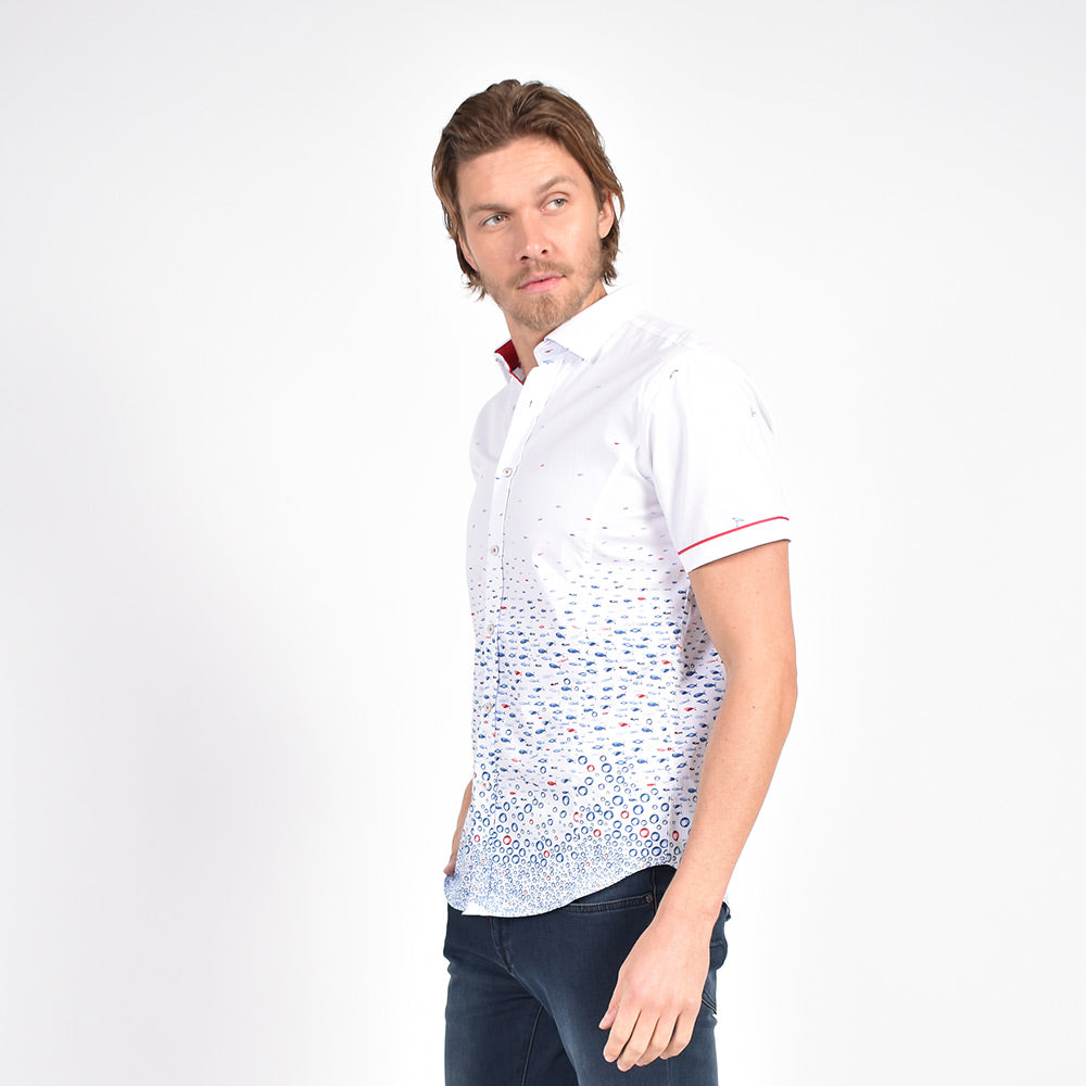 Model in white button up with small hummingbird and flounder pattern.