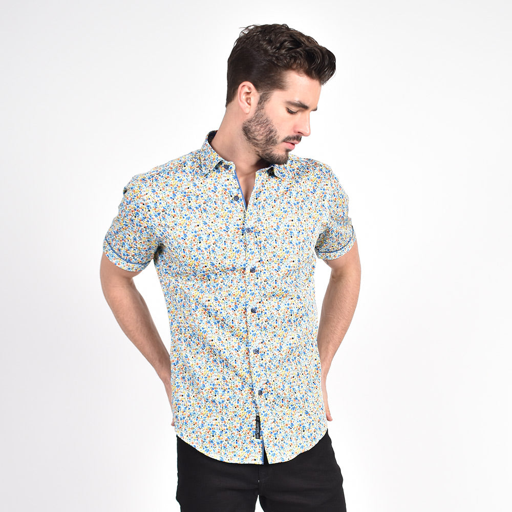 Model in short-sleeve button-up with multi-colored floral print.