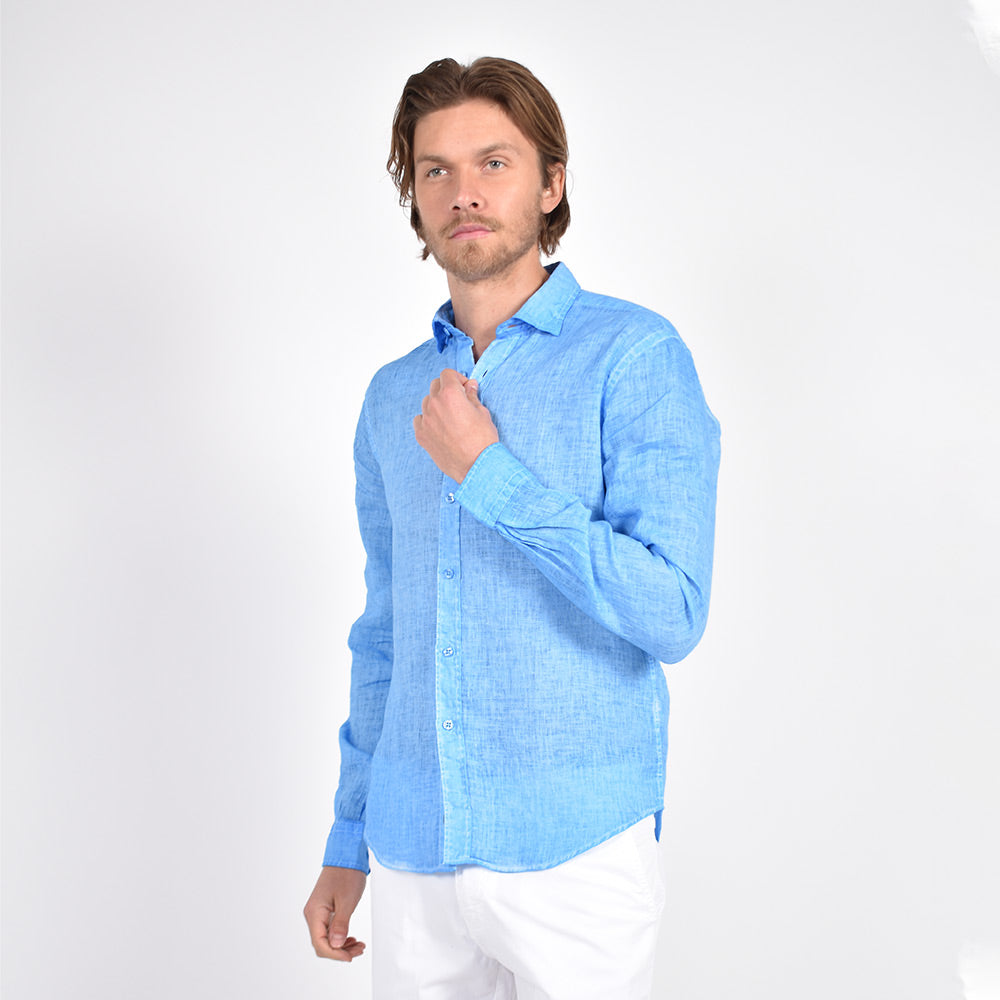 Model in long-sleeve, solid blue linen button-up. 