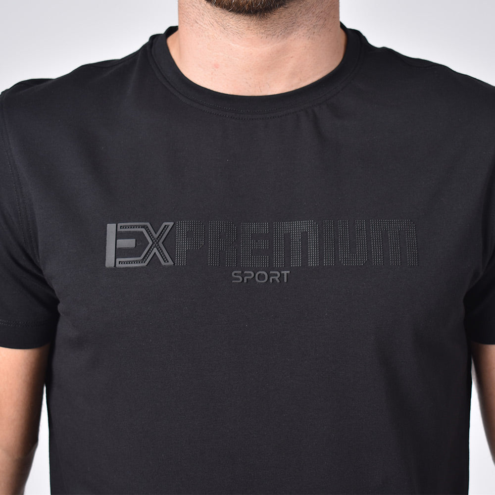 Detail of silicone "EX Premium Sport" logo on front of shirt. 