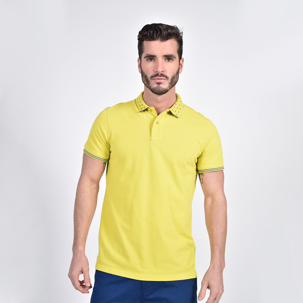 Model in yellow polo with diamond grid jacquard collar; two-button placket; and striped ribbed armbands.