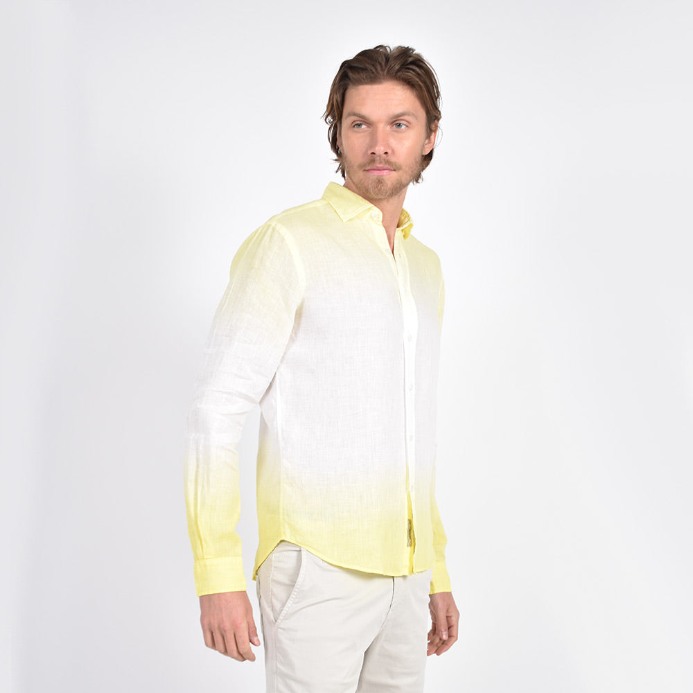 Model in long-sleeve, white linen button up with yellow ombre finish on top of shirt and bottom hem.