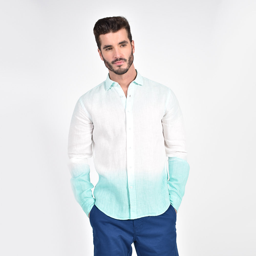 Model in long-sleeve, white linen button up with mint-green ombre finish on top of shirt and bottom hem.
