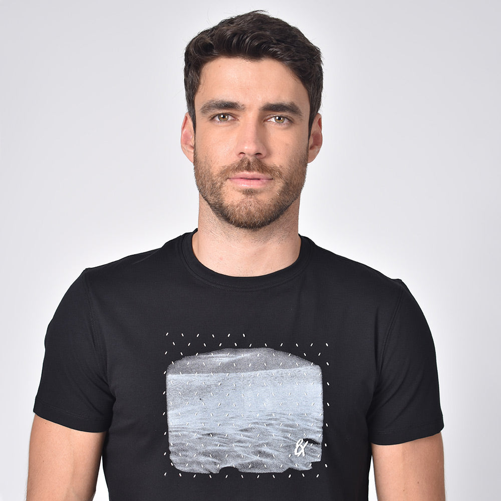Model in black, short-sleeve cotton crew-neck with silicone print design on front.