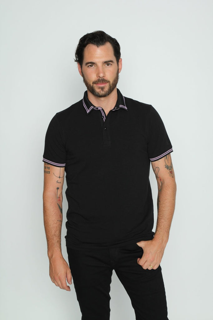 Black polo with tipped collar; two-button, lilac-trimmed placket; and striped, ribbed armbands.