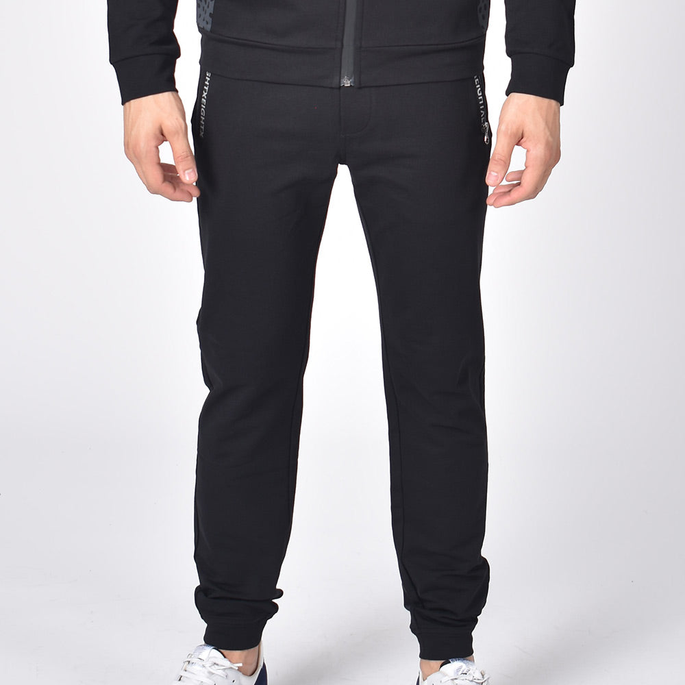 Black, cotton joggers with tapered fit, zip-pockets, and drawstring waist. 