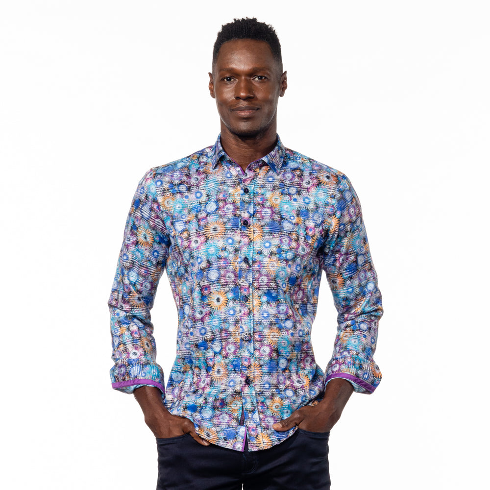 Model in button up with multi-colored digital daisy print. Features purple and mustard trim.