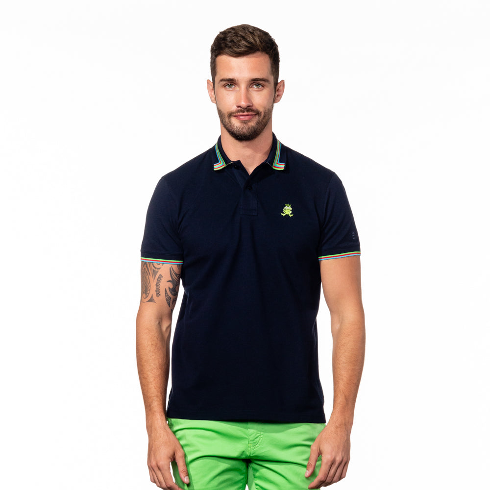 Model wearing navy blue polo with striped tipped collar, matching ribbed armbands, and embroidered green frog mascot. 