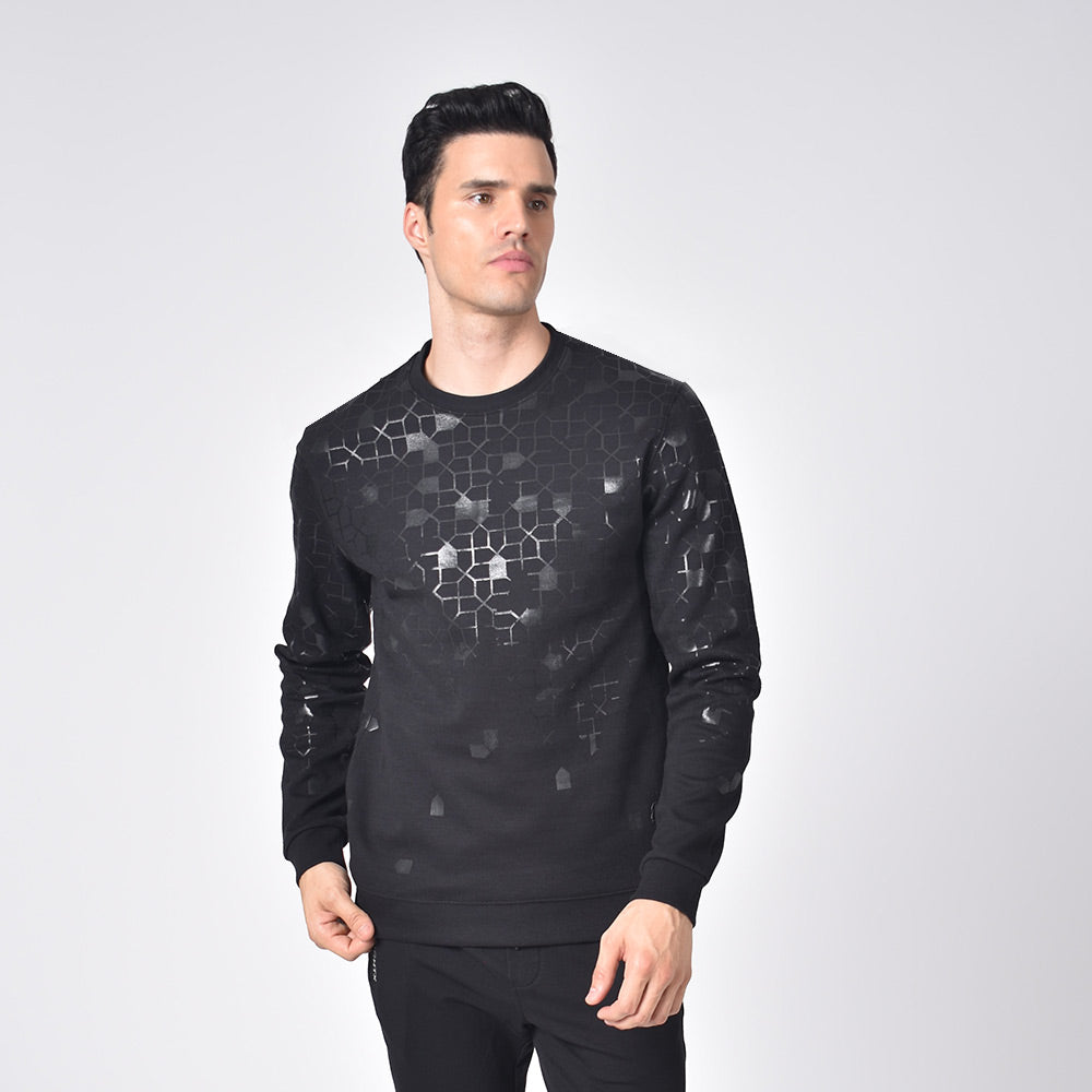 Model in black, long-sleeve, crew-neck sweatshirt with black mosaic design. 