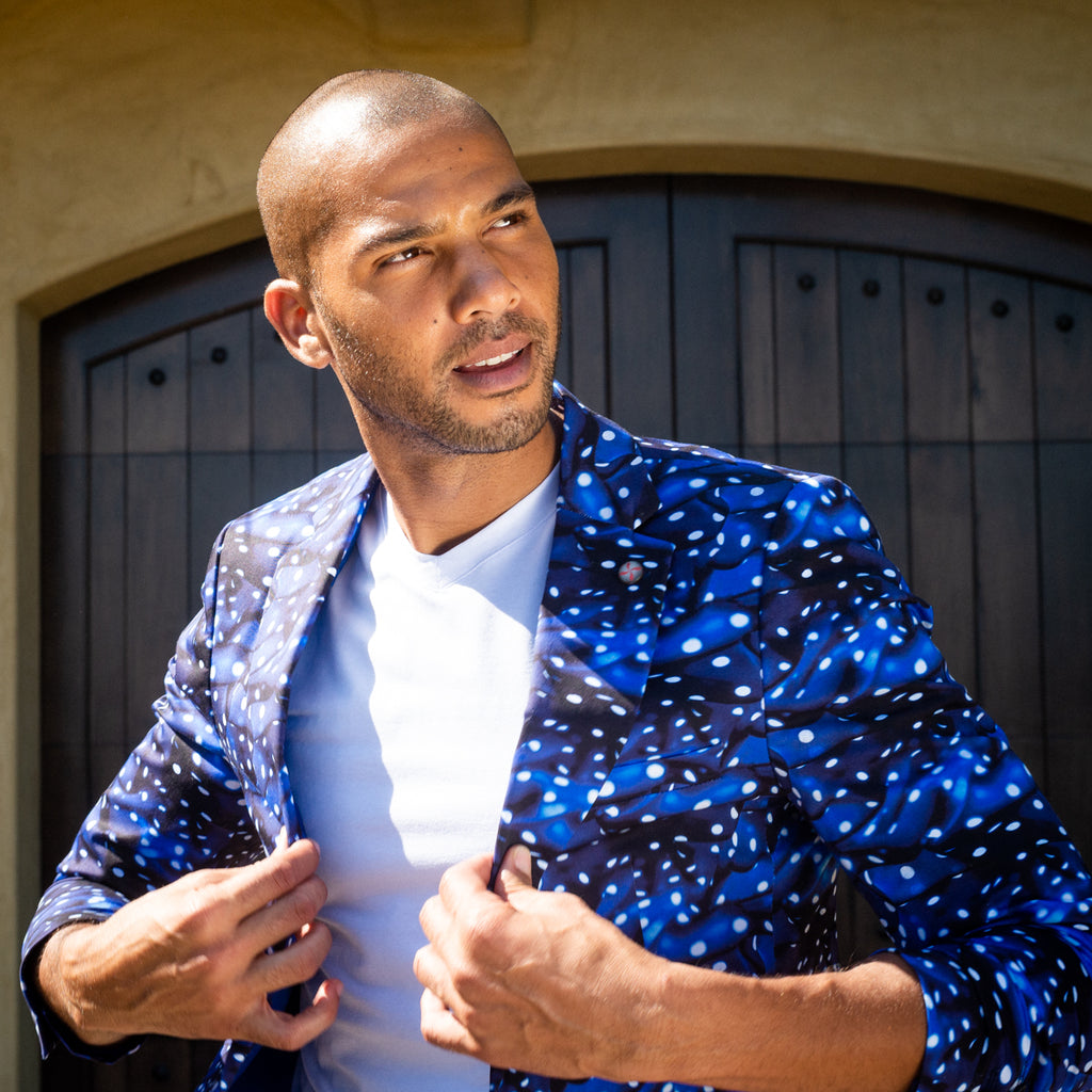 Model wearing blue and black luxury blazer with dashes of white