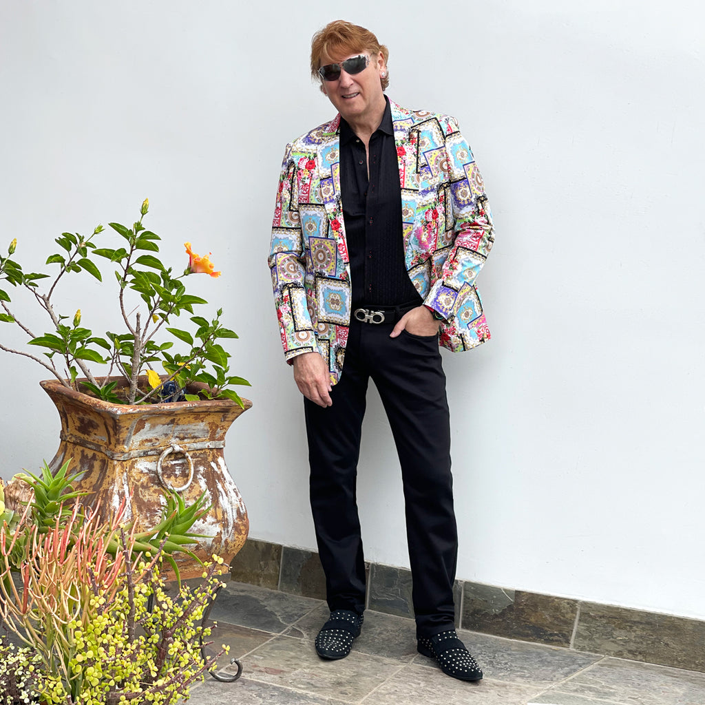 Producer Michael wearing houses of the holy multi-color blazer