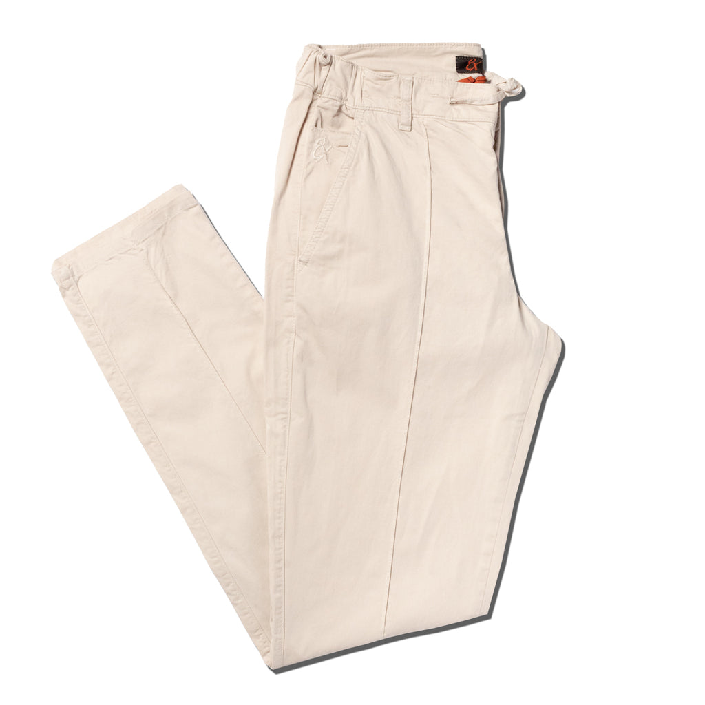 Folded beige chino pants with drawstring waist with a stitch going down the middle of the legs