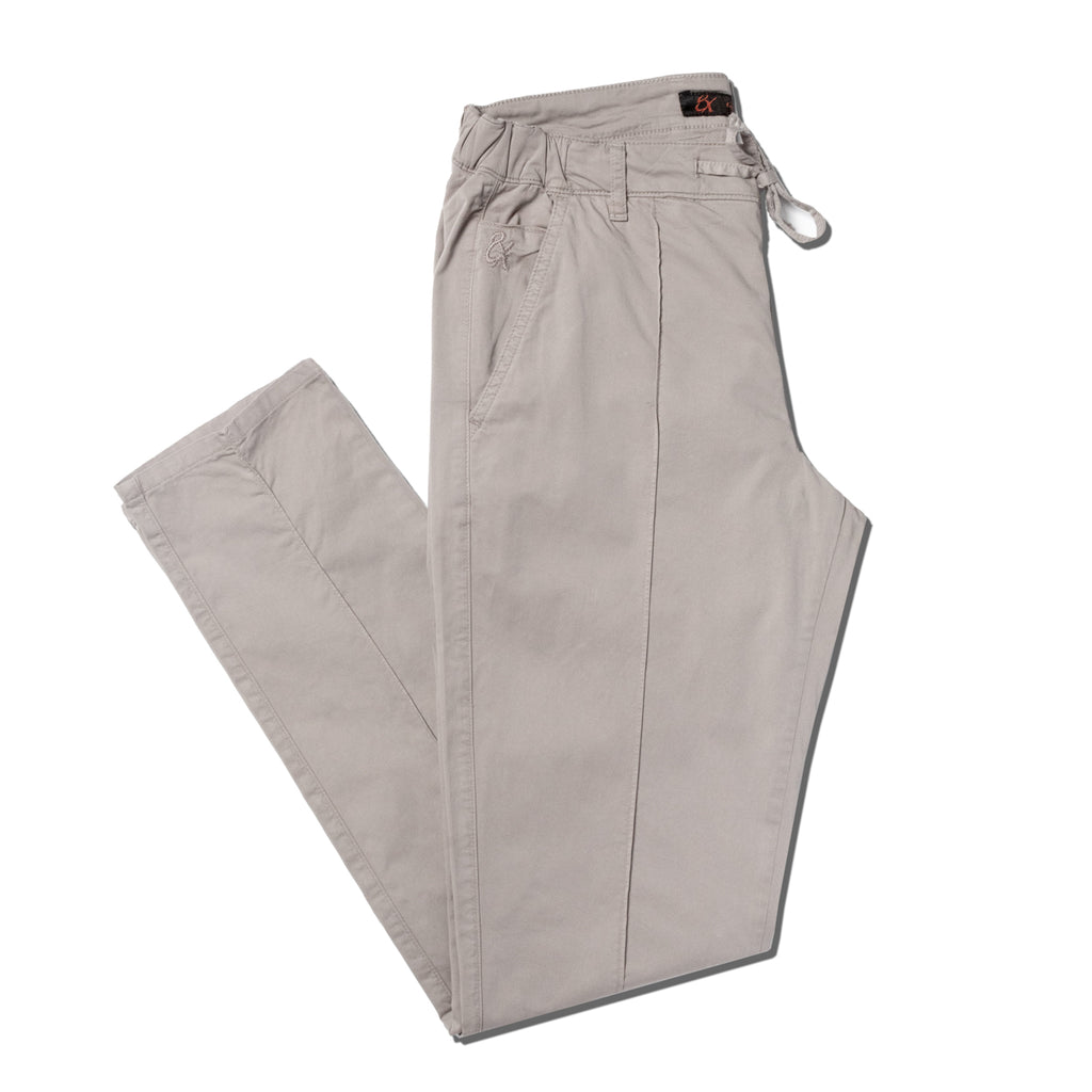 Folded beige chino pants with drawstring waist with a stitch going down the middle of the legs