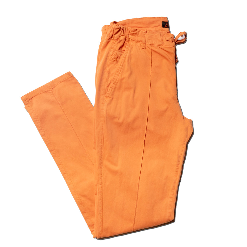 Folded orange chino pants with drawstring waist with a stitch going down the middle of the legs