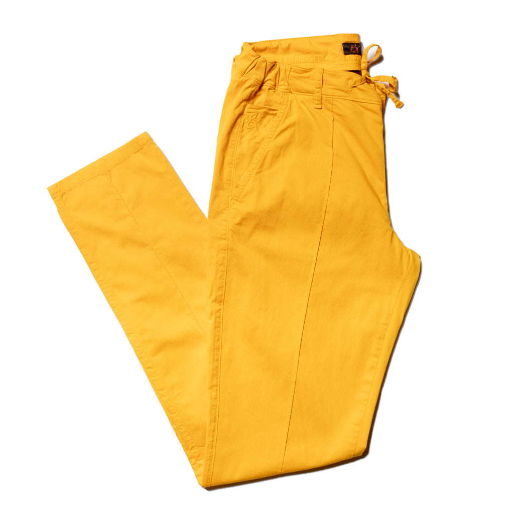Folded yellow chino pants with drawstring waist with a stitch going down the middle of the legs