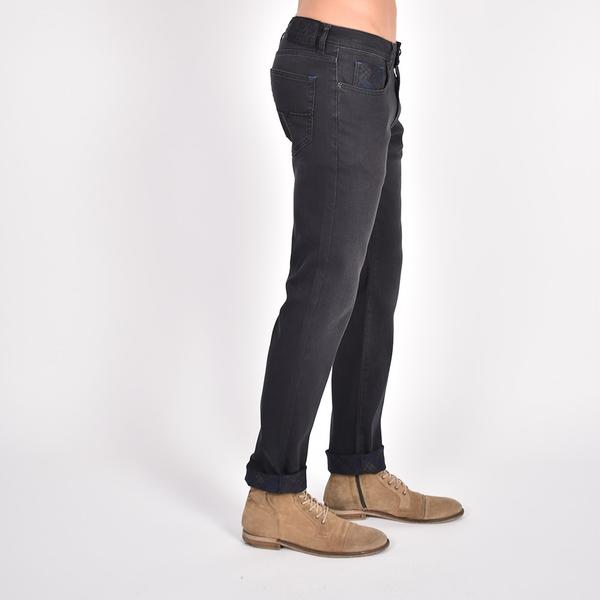 Side view of black slim-fit jeans with interior print.