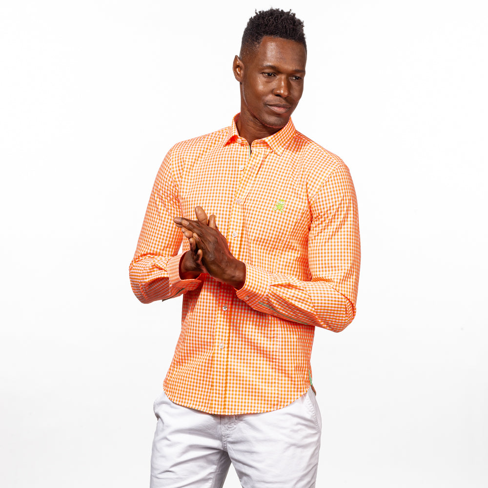 Model in bright-orange gingham button up with green trim, and green embroidered frog.