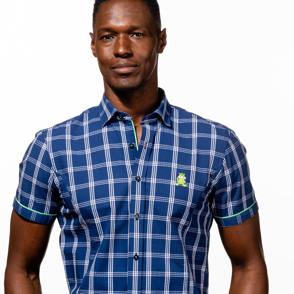 Model in short-sleeve, navy-blue plaid seersucker button up with green trim; green, embroidered frog; and navy-blue buttons.