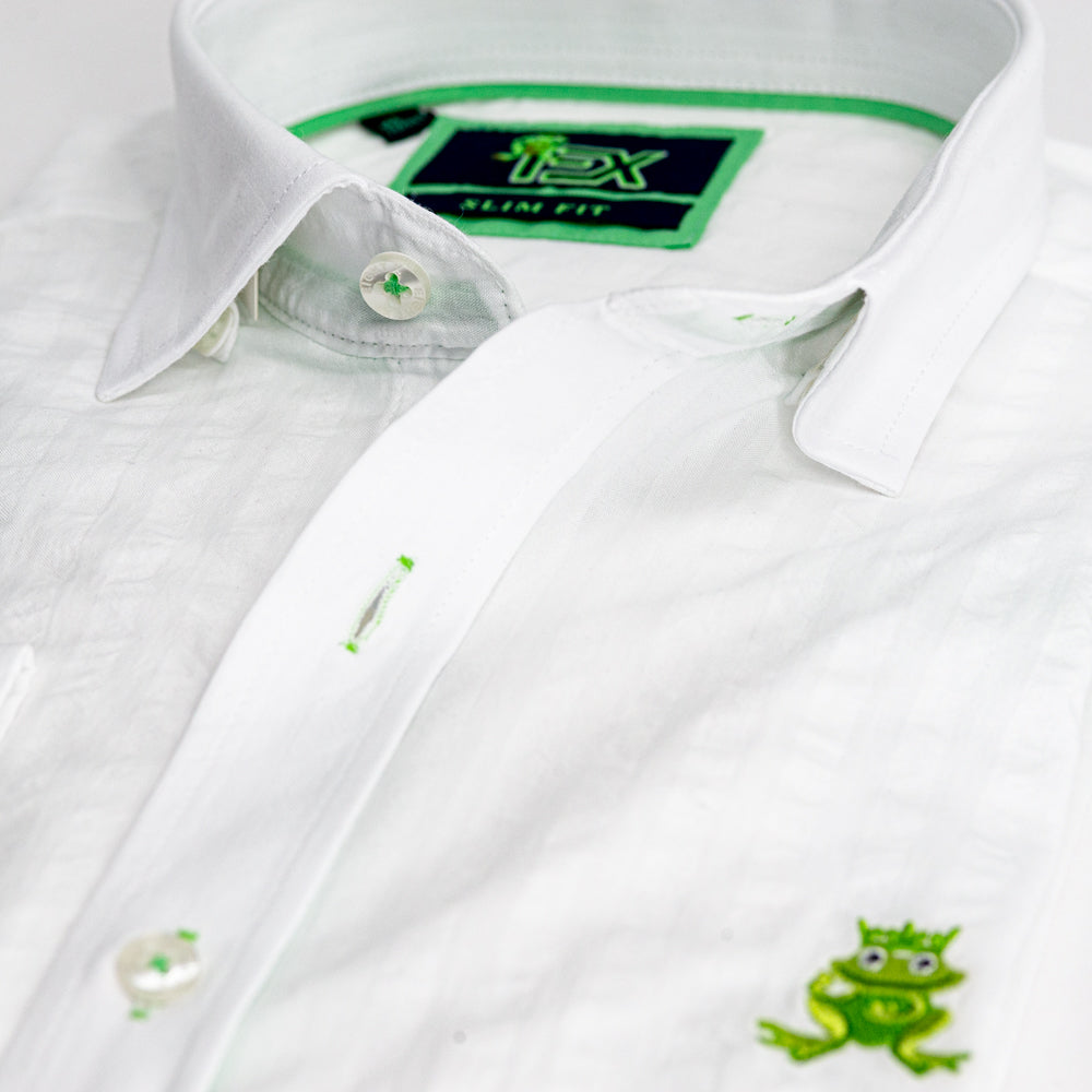 Detail of white seersucker’s collar, green trim, and embroidered frog.
