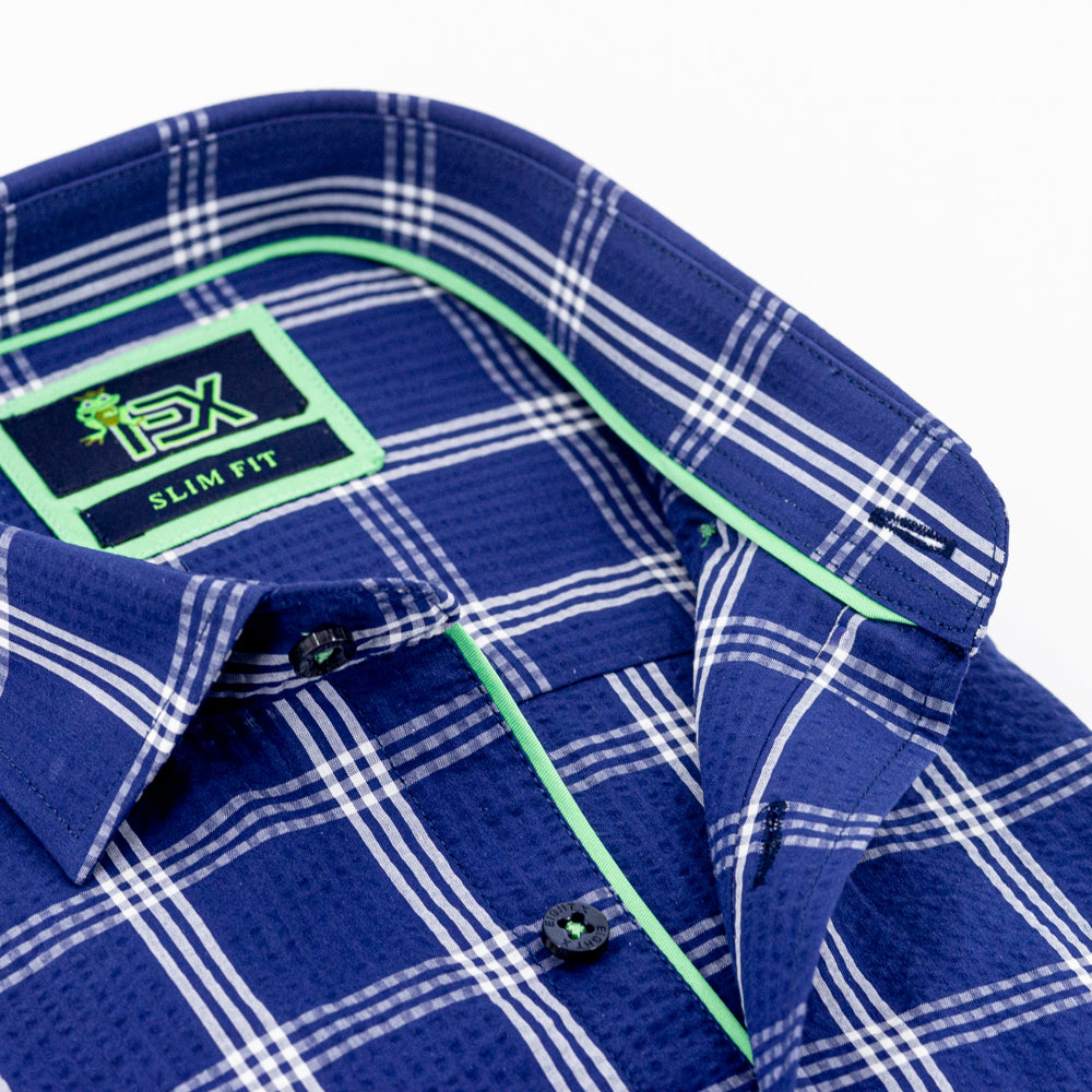 Detail of navy-blue, plaid seersucker’s collar, green trim, and navy-blue buttons.