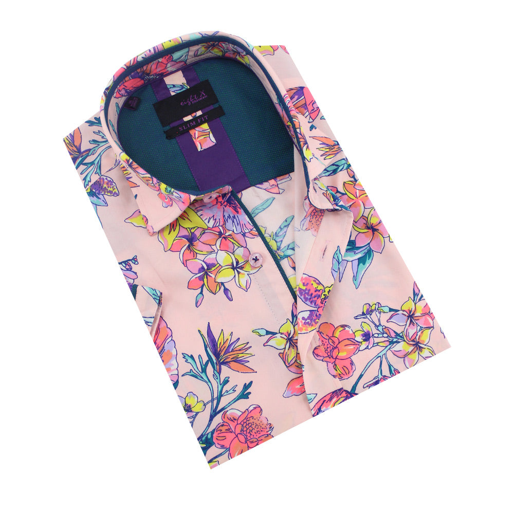 Folded light-peach button-up with tropical floral print and teal front-yolk.