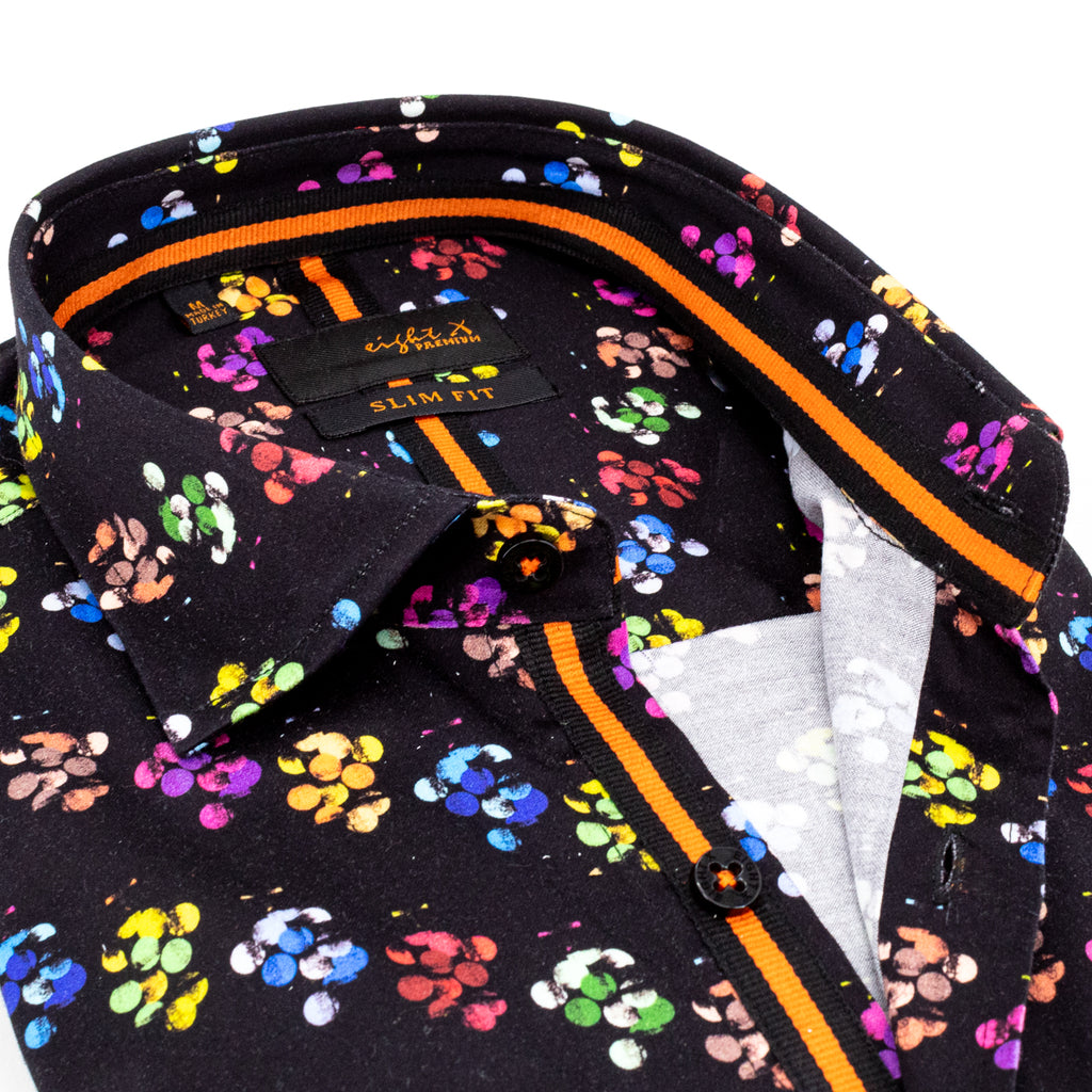 Close-up of black button down shirt with colorful clusters of dots and an orange trim
