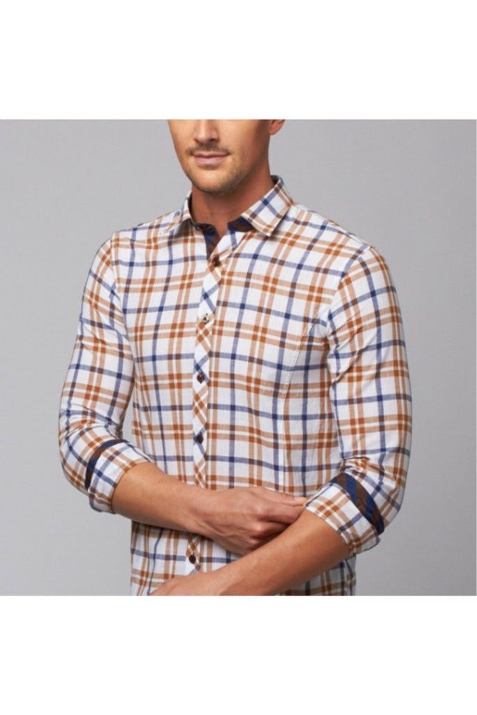 Model in long sleeve, camel plaid linen button up with navy checkered trim. 