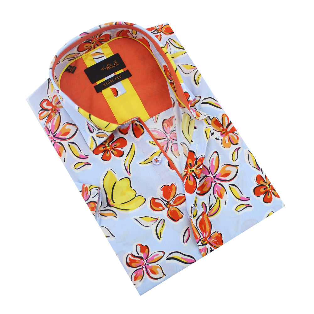 Folded light blue button-up with orange, Hawaiian flower print.