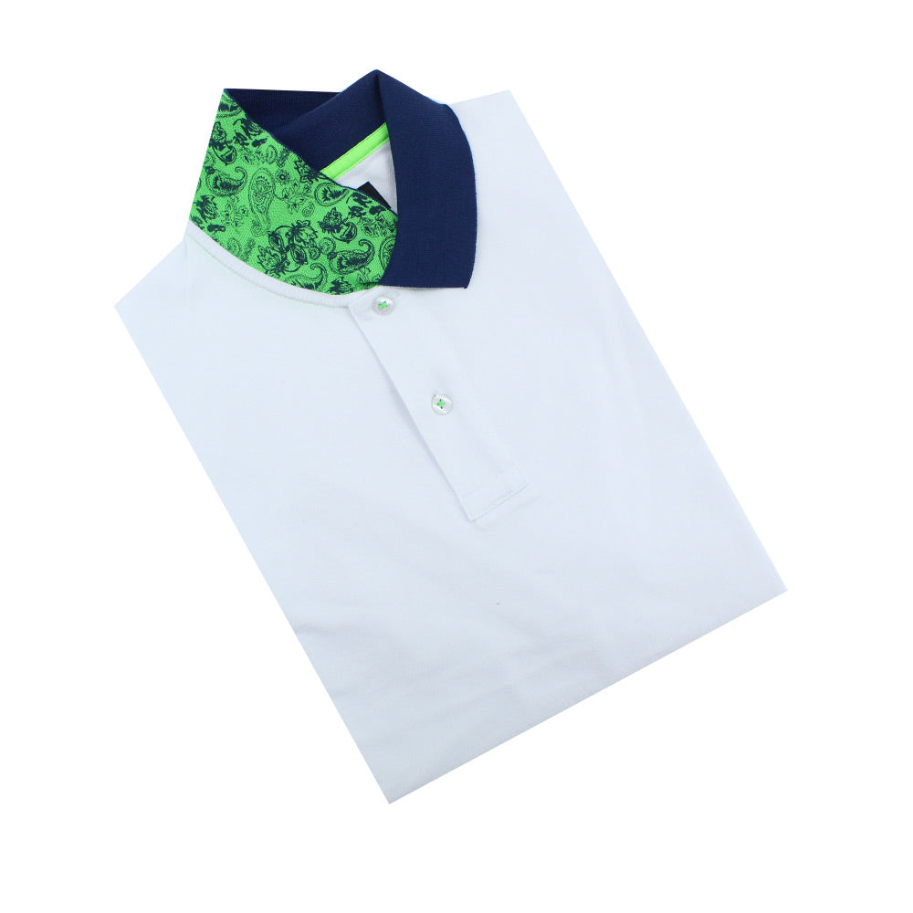 Folded white polo with two-button placket and reversible navy collar: green and navy-blue paisley print on reverse.