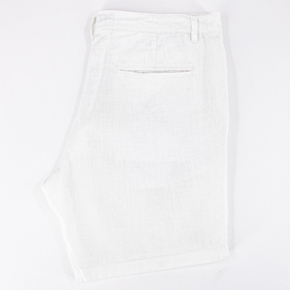 Folded white linen shorts with back welt pocket.
