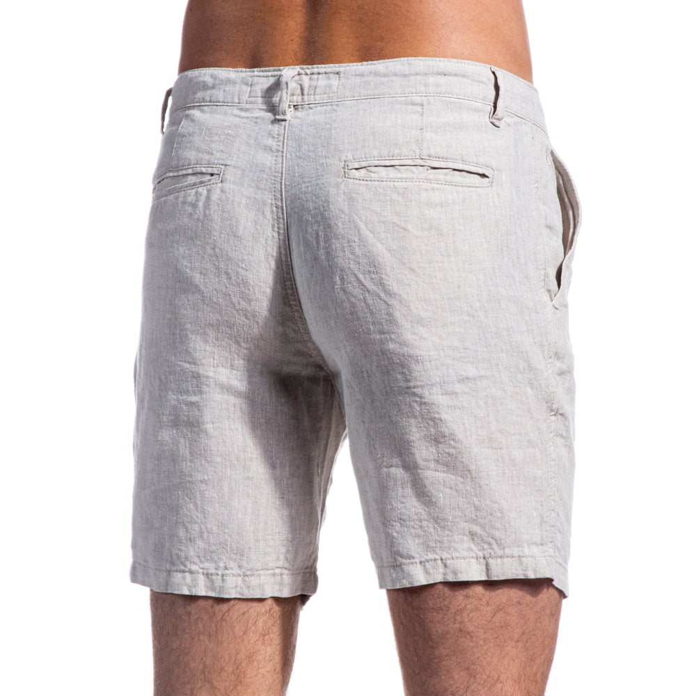 Picture of backside of beige linen shorts. Includes two welt pockets.
