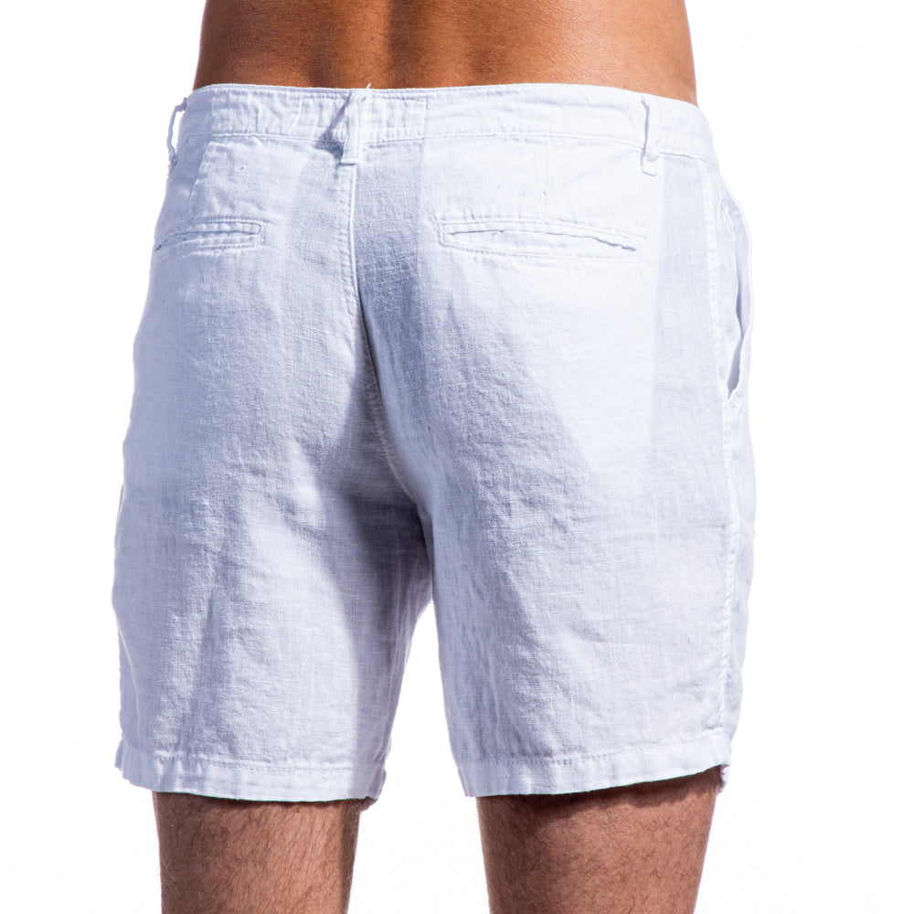 White Linen Shorts on Model. Back Angle View, Features Two Welt Pockets.