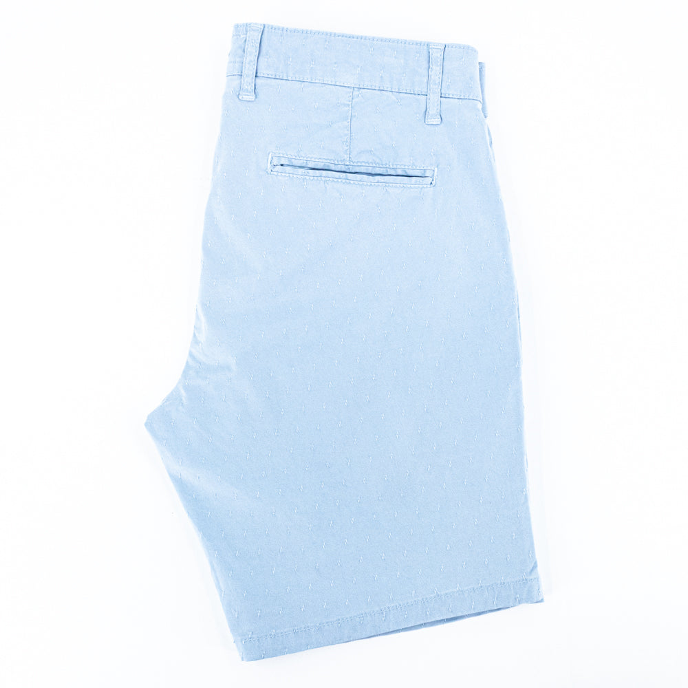 Folded light-blue shorts with back welt pocket.