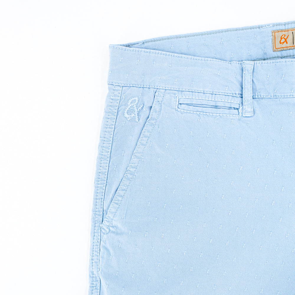 Detail of jacquard texture and embroidered logo on front right-pocket.
