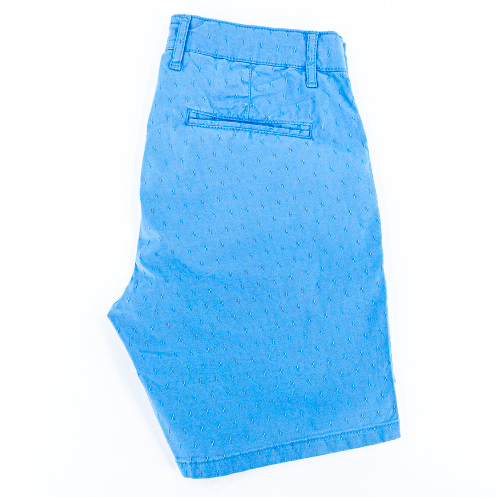 Folded turquoise shorts with back welt pocket.