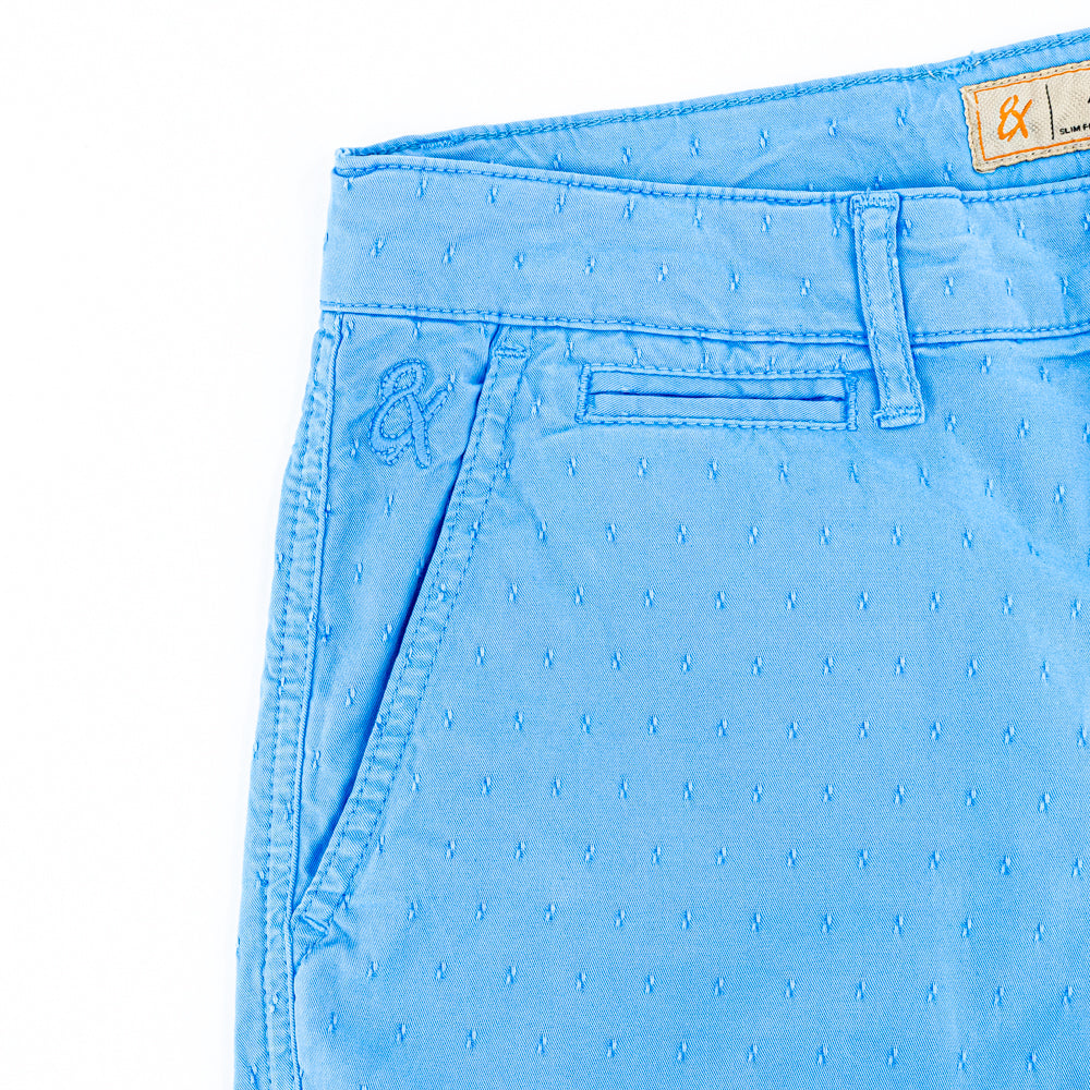 Detail of jacquard texture and embroidered logo on front right-pocket.