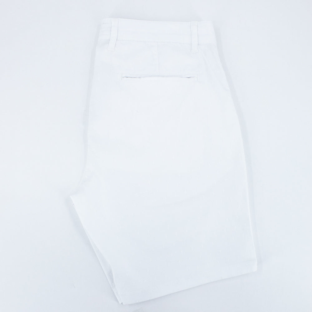 Folded white shorts with back welt pocket.