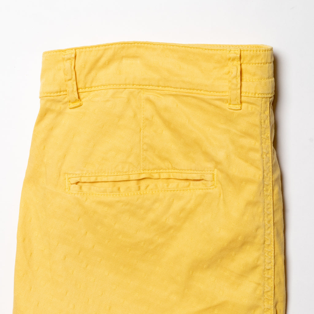 Back pocket view of yellow jacquard textured shorts