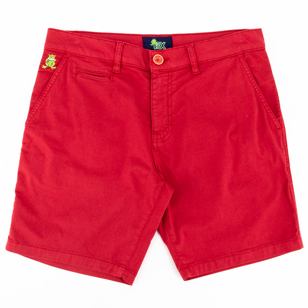 Flat-lay of bright-red shorts with two front pockets; one welt pocket; and green embroidered frog mascot on right front-pocket.