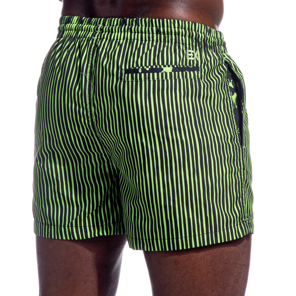 Back Angle View. Features Welt Pocket. Model Wearing Green and Black Striped Swim Trunks. Mid Thigh Cut.