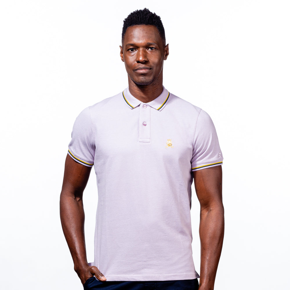 Model in lilac polo with tipped collar, two-button placket, and striped, ribbed armbands. Featuring embroidered gold frog mascot.