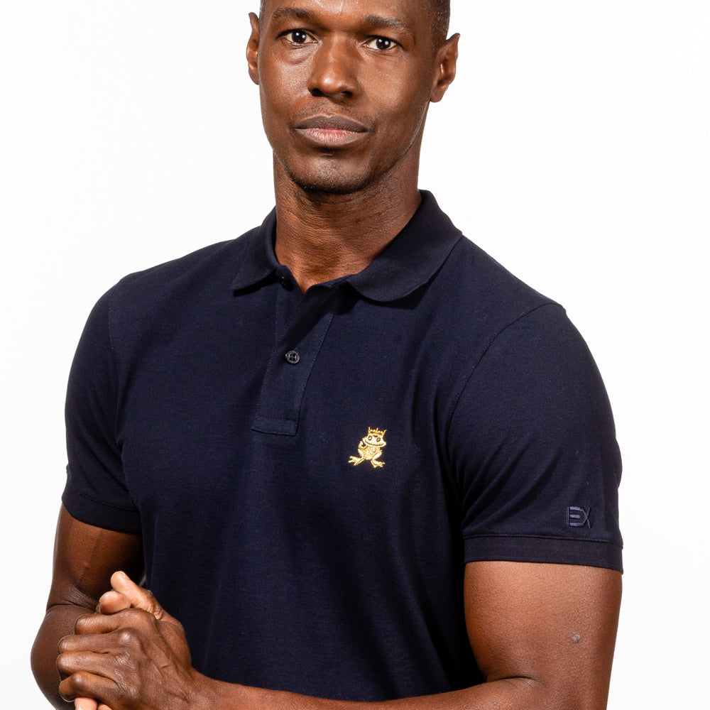 Model in navy-blue  polo with two-button placket, ribbed armbands, embroidered gold frog mascot, and embroidered EX logo on left sleeve. 